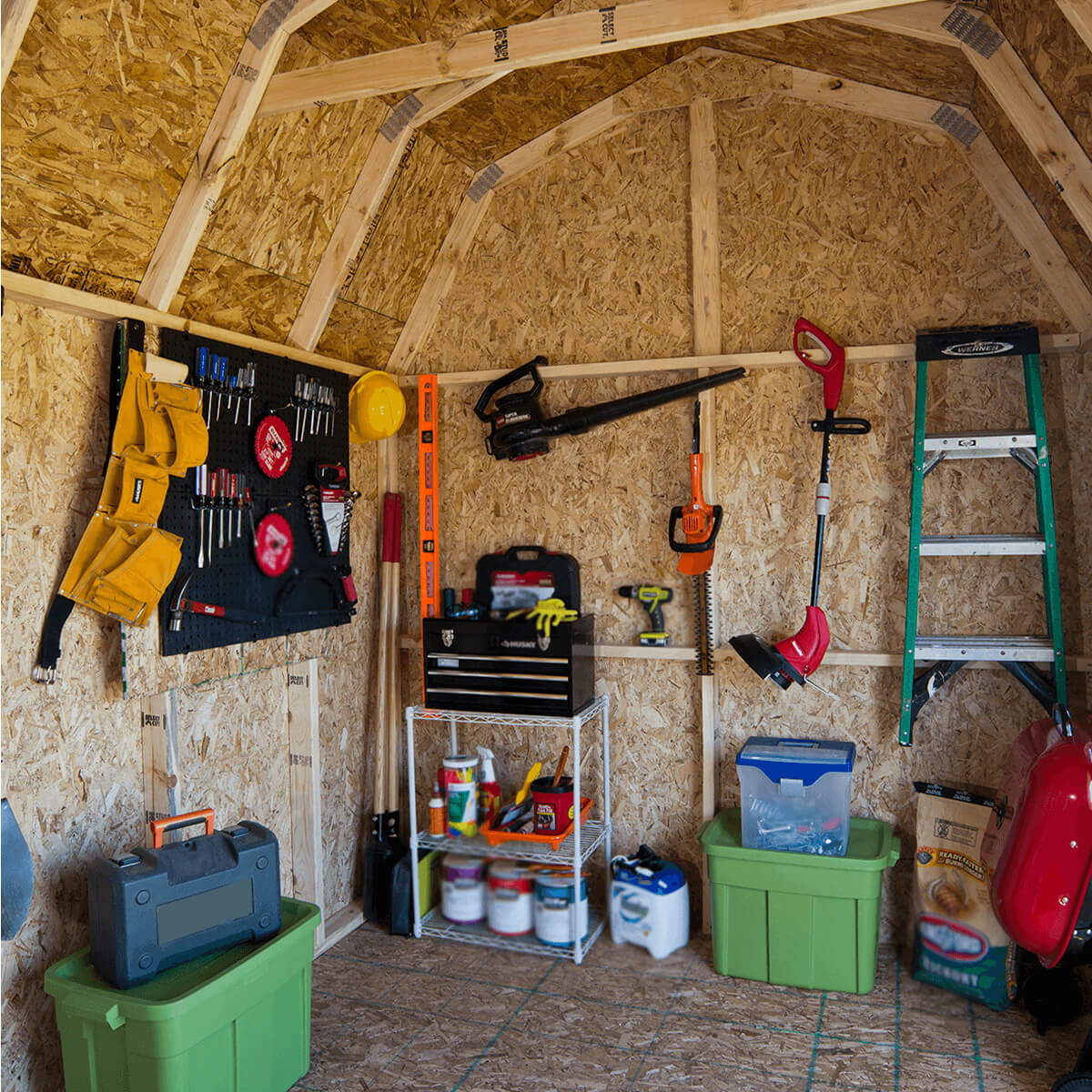 Interior of a storage shed with a tool wall, shelves, and gardening tools neatly organized. Interior of a storage shed with a tool wall, shelves, and gardening tools neatly organized.