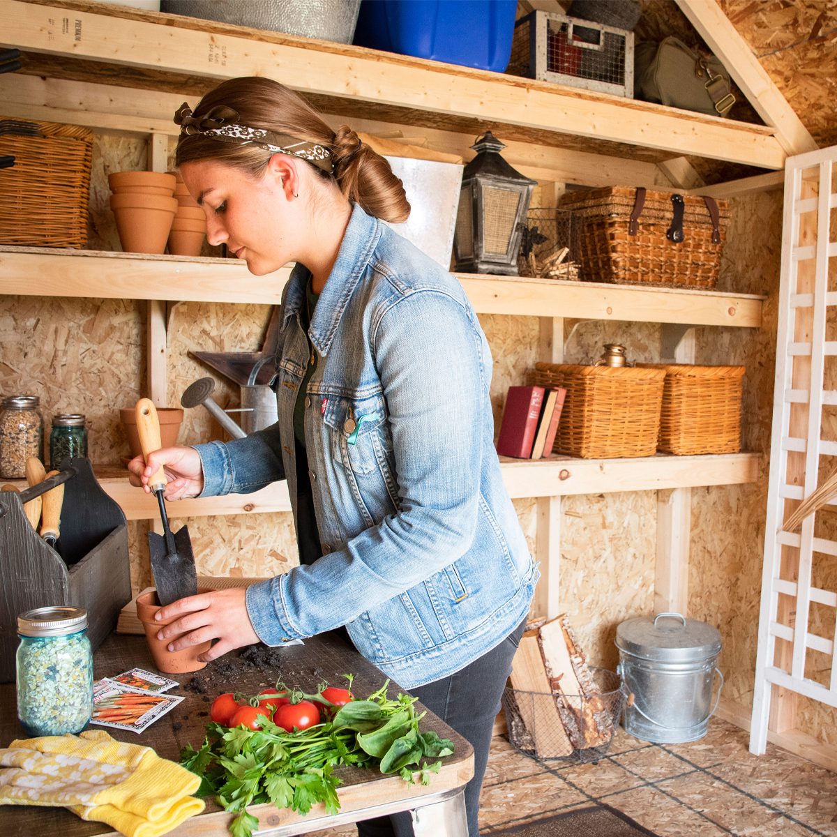 Woman working inside her gardening shed  Woman working inside her gardening shed