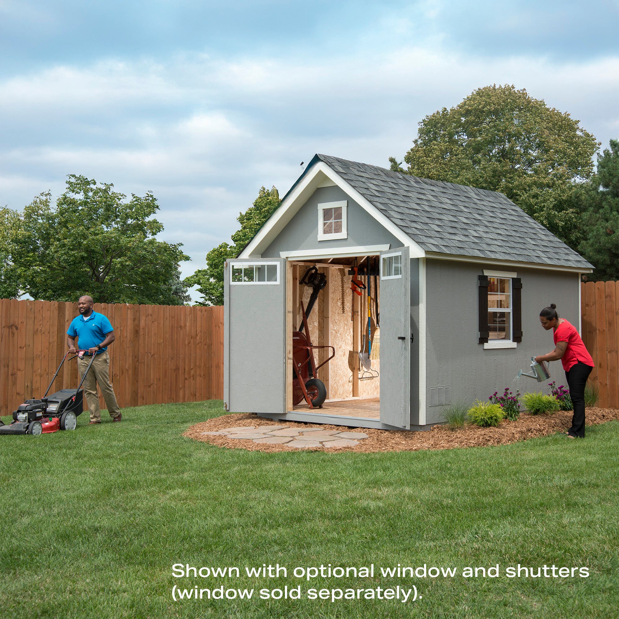 Storage shed with open doors revealing tools inside, with a man mowing and a woman gardening nearby. Storage shed with open doors revealing tools inside, with a man mowing and a woman gardening nearby.