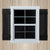 Window with black shutters on a wooden background