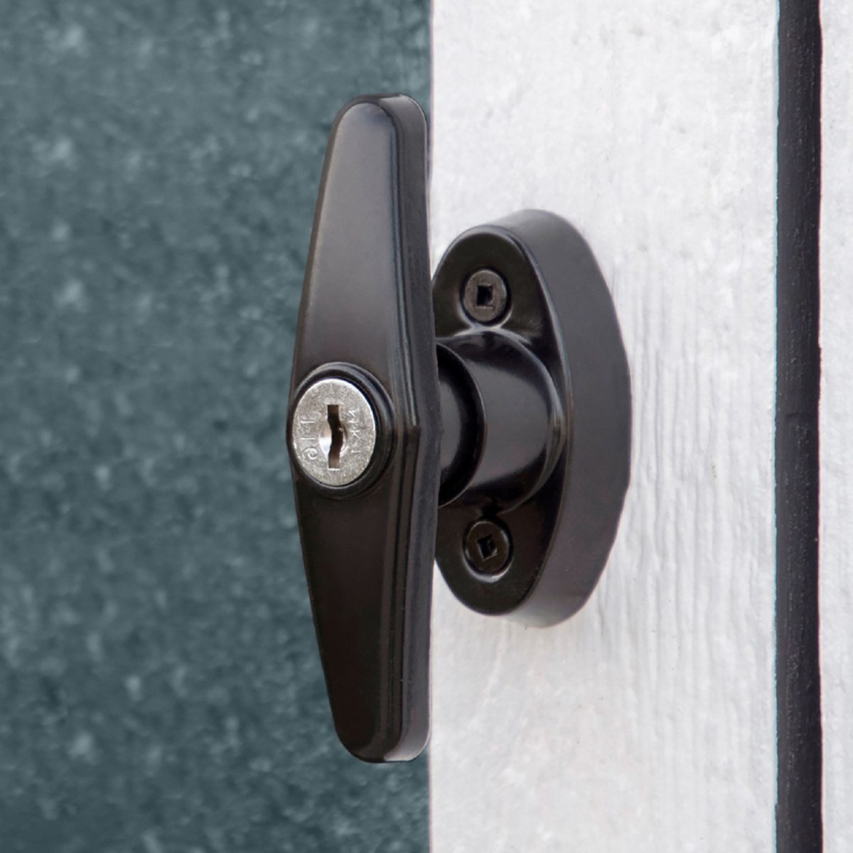 Close up of the metal handle and lock on the wooden shed