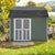 Storage shed with double screen doors and a shingle roof, set in a yard with fall foliage.