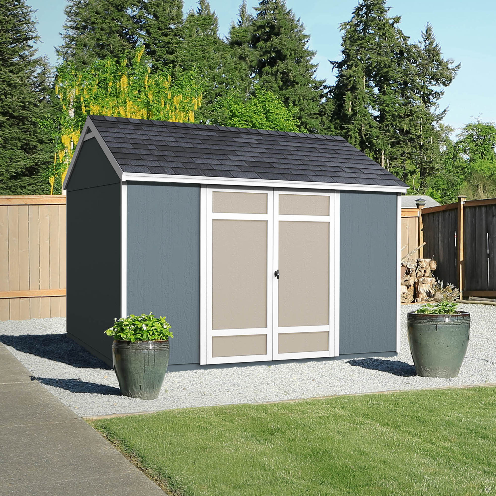Shed in a backyard with two pots outside 
