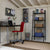  "Interior of a modern shed converted into a home office with a desk, red chair, shelving, and organized storage boxes
