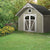 Spacious storage shed in backyard with flowers