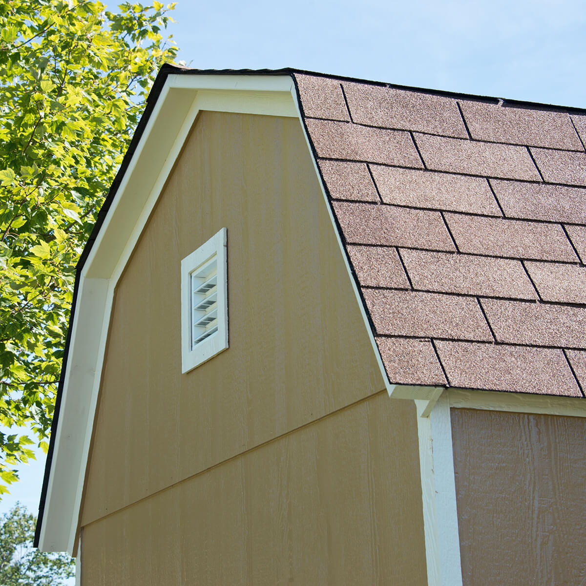 Close-up of a shed's gable roof with a vent for airflow.