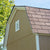 Close-up of a shed's gable roof with a vent for airflow.